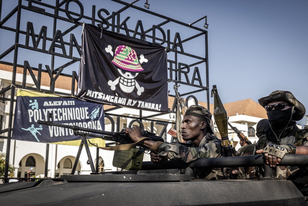 Madagascar: Members of Madagascar's Army CAPSAT unit ride an armoured vehicle past a large banner featuring a Malagasy version of the logo from the popular Japanese manga One Piece, a symbol adopted by Gen Z protest movements worldwide, at a civil society rally calling for President Andry Rajoelina's resignation, before heading to the Presidential Palace in Antananarivo, October 14, 2025. An elite Madagascar military unit told AFP on October 14, 2025 it had taken power in the country after the national assembly voted to impeach President Andry Rajoelina for desertion of duty.